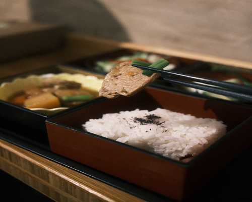 A freshly prepared home meal with balanced portions of rice, vegetables, and local tofu